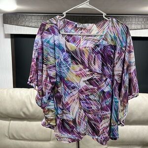 Jennifer López Blouse—very colorful. L